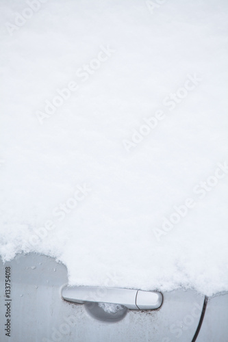 Snow-covered car door handle detail © bizoo_n