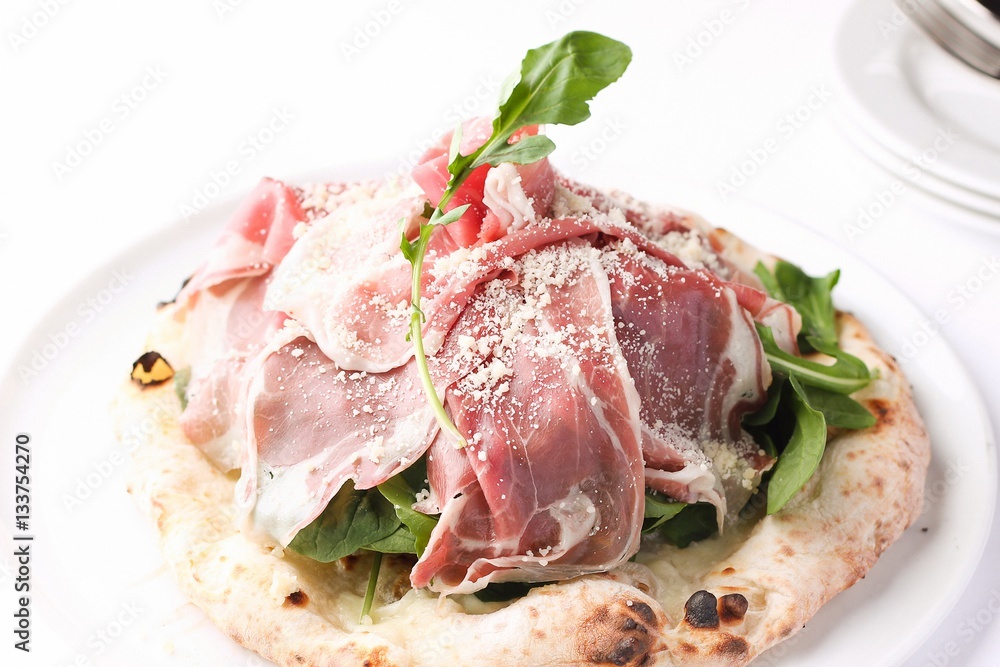 Prosciutto pizza on dish