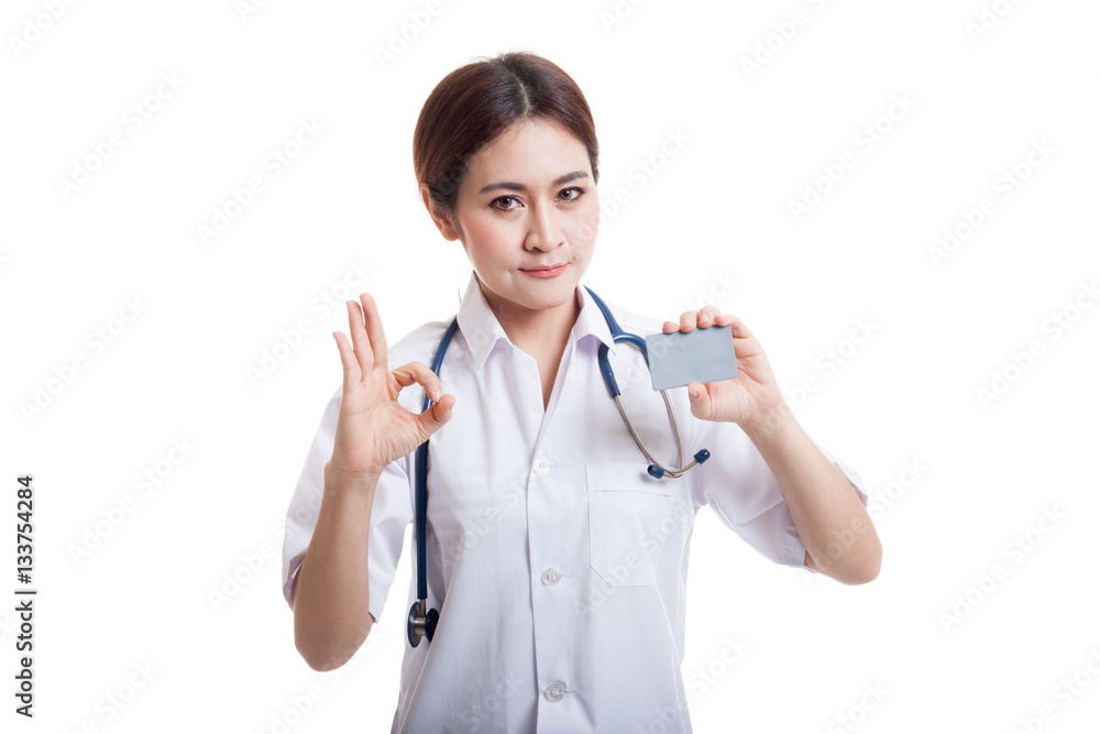 Asian young female doctor show Ok sign with blank card. Asian young female doctor show Ok sign with blank card.