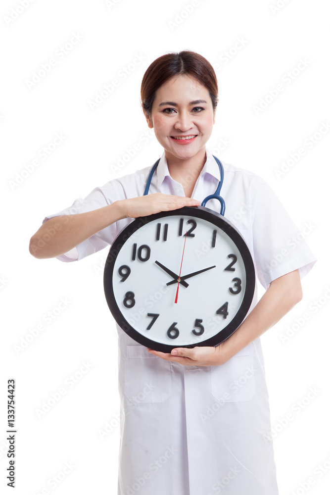Young Asian female doctor happy show a clock. Young Asian female doctor happy show a clock.