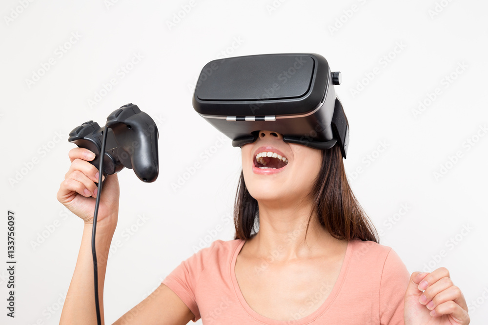 Excited Woman playing game on virtual reality device Excited Woman playing game on virtual reality device
