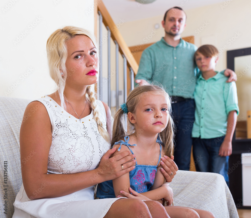 Fototapeta premium Parents and two kids in conflict at home.