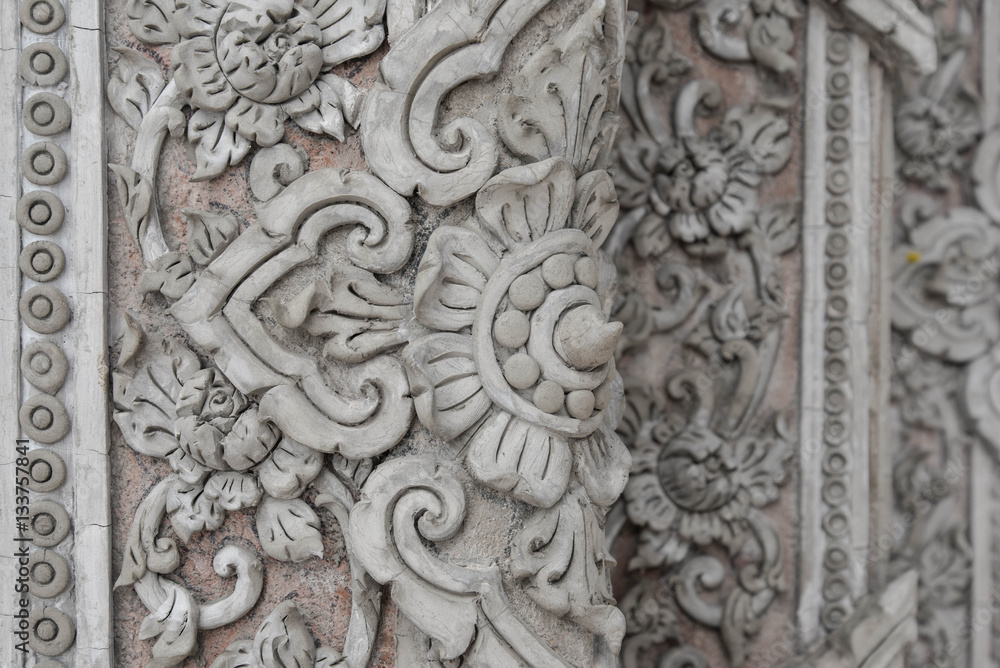 Plaster carvings of Thai style on the temple wall