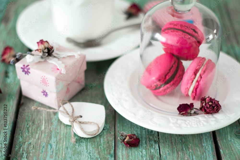 French macaroons cookies gift box and cappuccino cup on a wooden background. Mothers day or Valentines day greeting card French macaroons cookies gift box and cappuccino cup on a wooden background. Mothers day or Valentines day greeting card