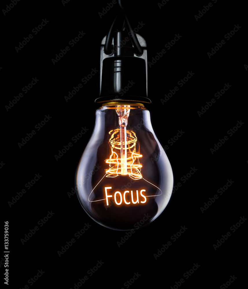 Hanging lightbulb with glowing Focus concept.