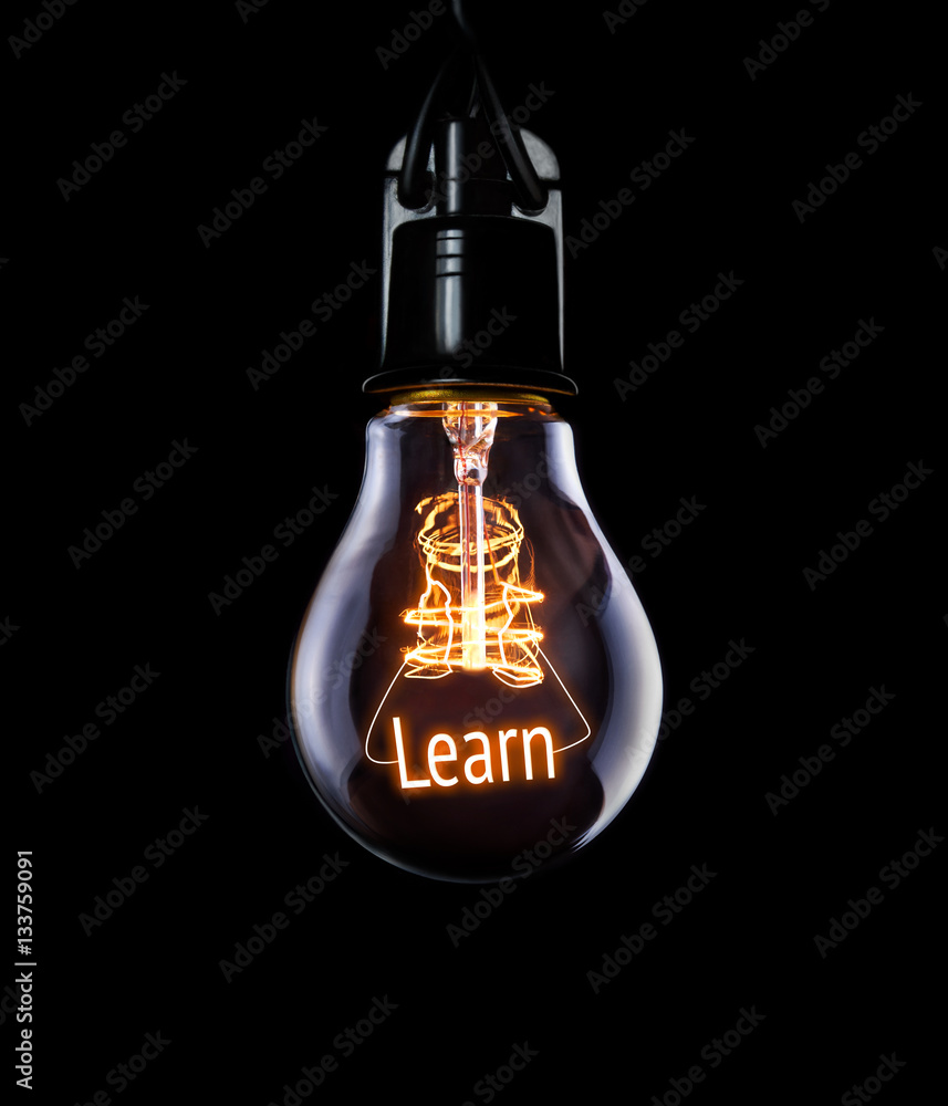 Hanging lightbulb with glowing Learn concept.
