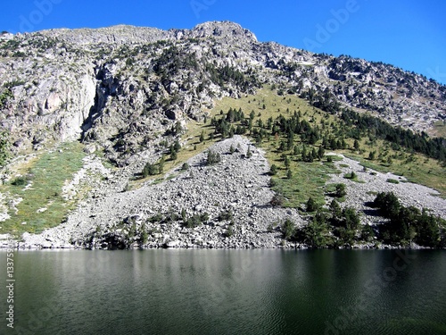 mountain with scree and lake