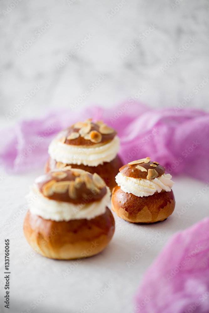 Fresh baked homemade buns on the table for breakfast Baking traditional Swedish semla bread Fresh baked homemade buns on the table for breakfast Baking traditional Swedish semla bread