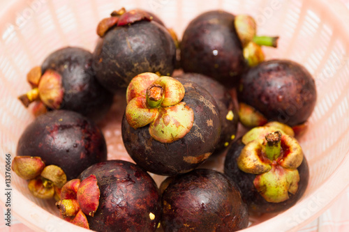 Mangosteens in basket on a table close up.