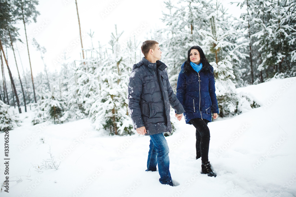 Active couple at a winter forest