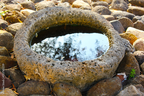 Stone jar with water photo