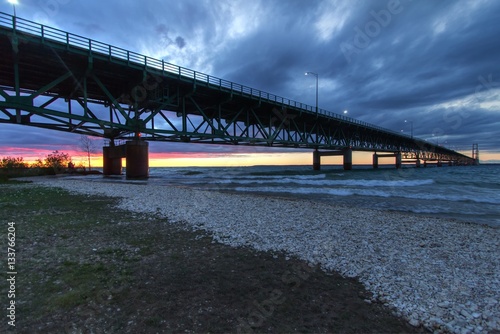 Mackinaw Bridge. The Mackinac Bridge is one of the longest suspension bridges in the world. It connects Michigan's Upper and Lower Peninsula. It is also part of the North Country Trail. © ehrlif