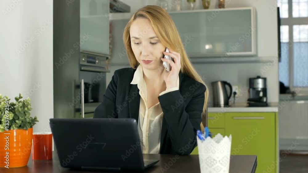 Businesswoman having a call and working on laptop in the apartment, steadycam shot
Businesswoman having a call and working on laptop in the apartment, steadycam shot