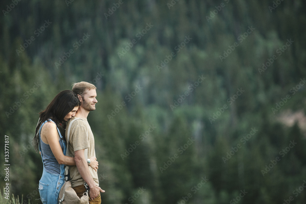 A couple standing embracing in the mountain landscape. A couple standing embracing in the mountain landscape.