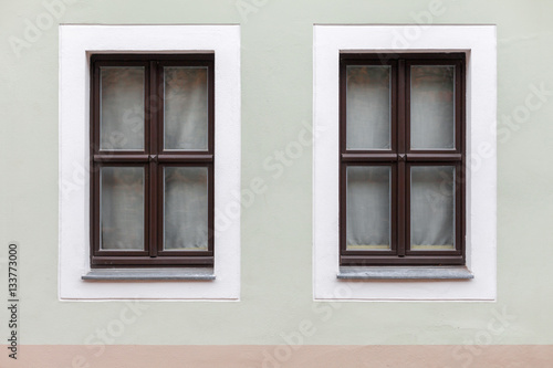 Dark wooden windows on a single wall