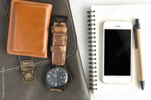 smartphone on the book and bag, clock on white background