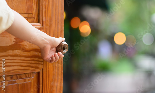 Women hand open door knob or opening the door.