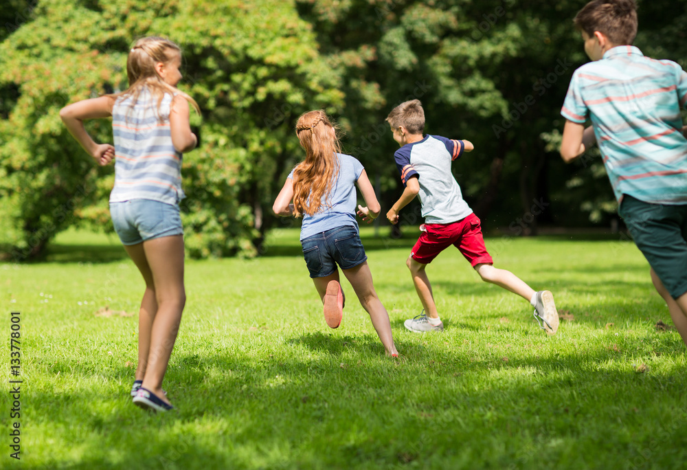 group of happy kids or friends playing outdoors