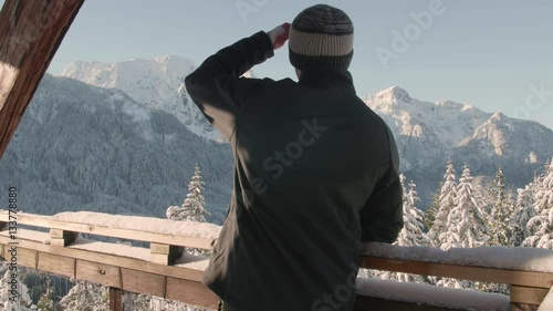 Man Views Snowy Mount Index from Heybrook Lookout Observation Tower in Pacific Northwest photo