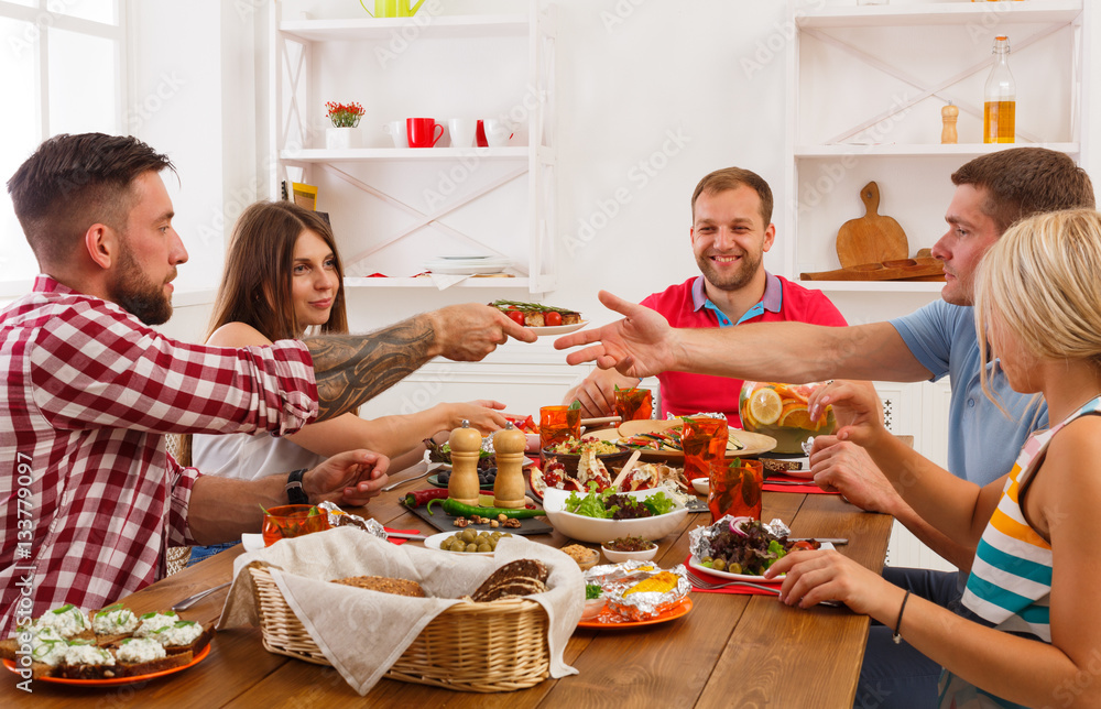 People eat healthy food at festive table dinner party