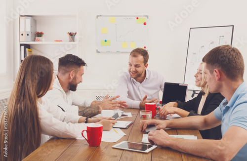 Business meeting. Young hipsters businessmen and women at modern