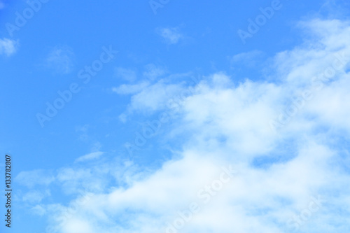 Clear white fluffy clouds in a blue sky. Sky background with blank space for text.