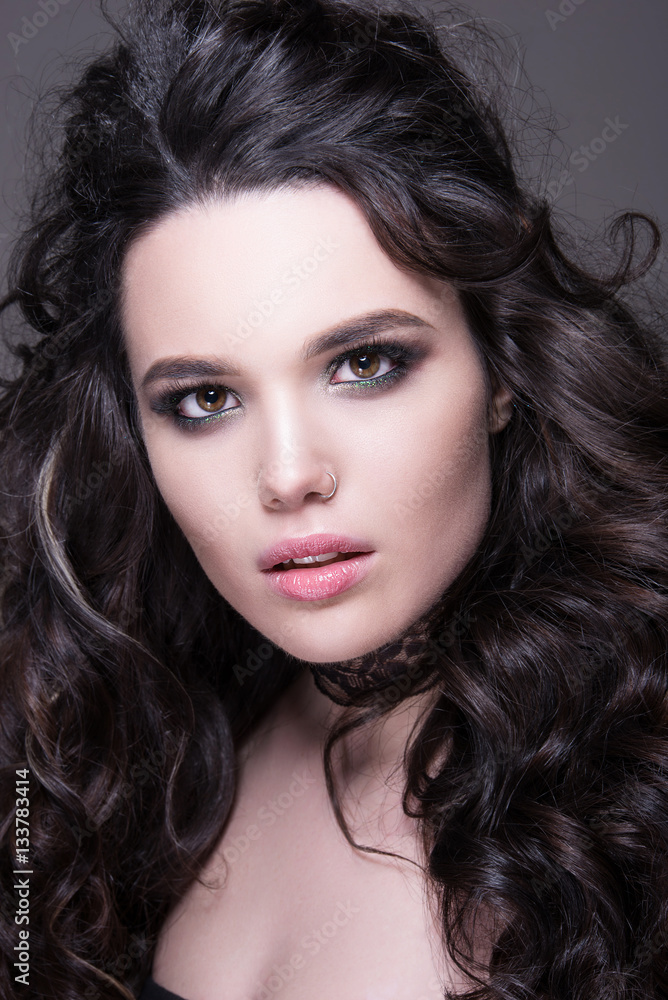 Close-up portrait of beautiful seductive woman with bright makeup and perfect hairstyle. Close-up portrait of beautiful seductive woman with bright makeup and perfect hairstyle.