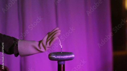 tesla coil with spark and Rubber glove touch it photo