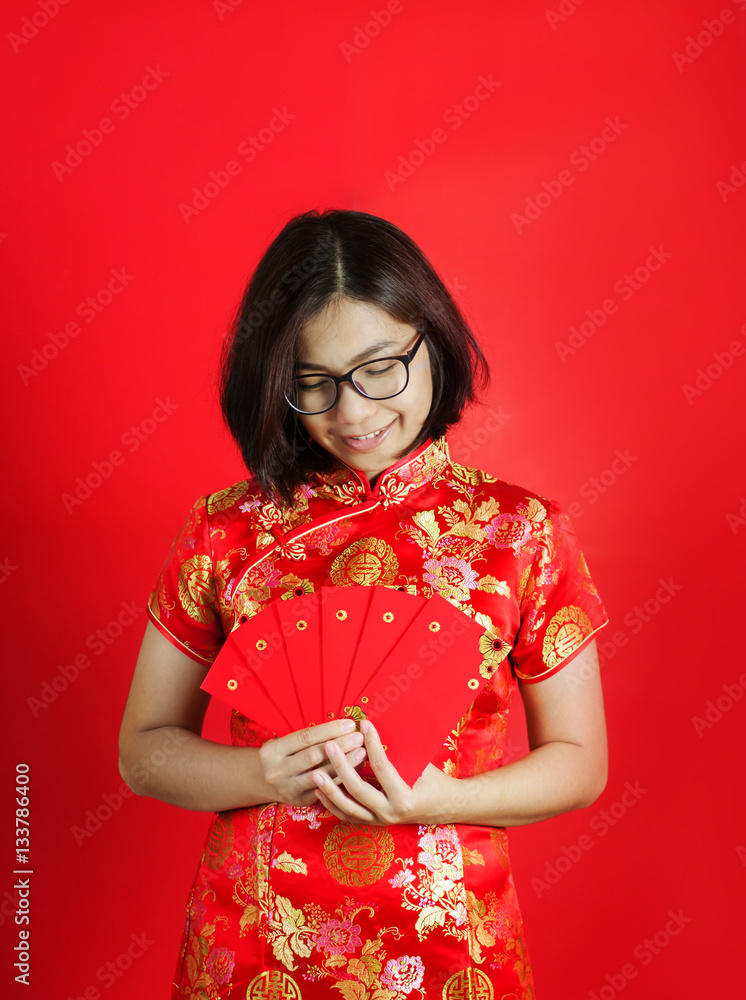 Asian glasses woman with cheongsam holding red envelopes . Asian glasses woman with cheongsam holding red envelopes .