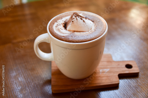 hot coffee cup on wooden table on brown background