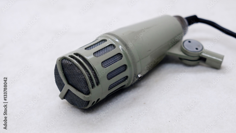 old microphone on light background old microphone on light background