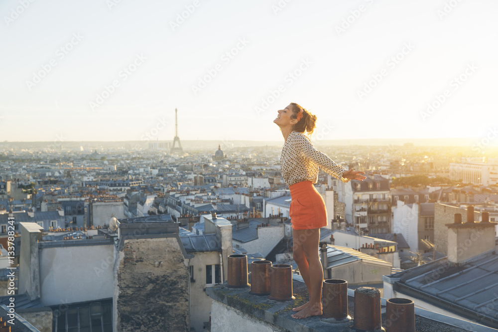 Paris, Happy woman enjoying view on the roofs of Paris