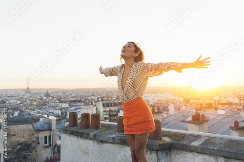 Paris, Happy woman enjoying view on the roofs of Paris