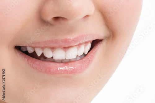Women smile. Face. White teeth. Photo closeup
