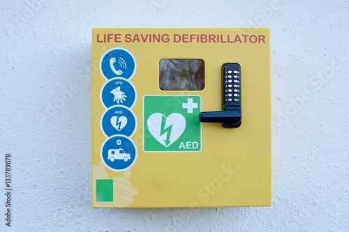 Automated external defibrillator mounted on a outside wall photo