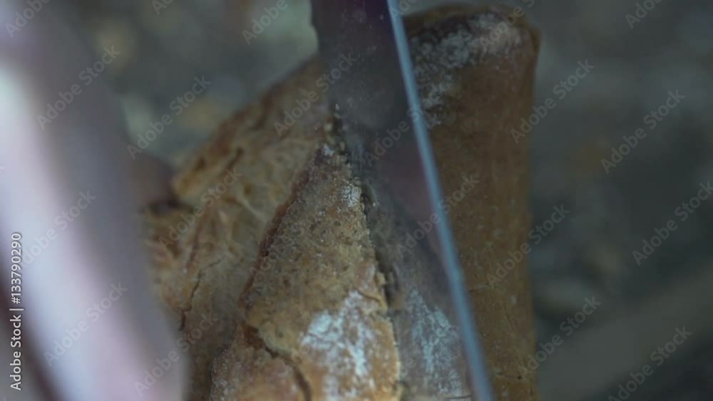Close up of female hands slicing white bread, super slow motion 240fps
Close up of female hands slicing white bread, super slow motion 240fps