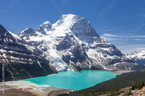 Panoramic view of Mt Robson mountain with glacier and lake during day with amazing summer colors in daylight and blue sky no clouds and mirror reflection in the water , Canadian Rockies in Canada.
