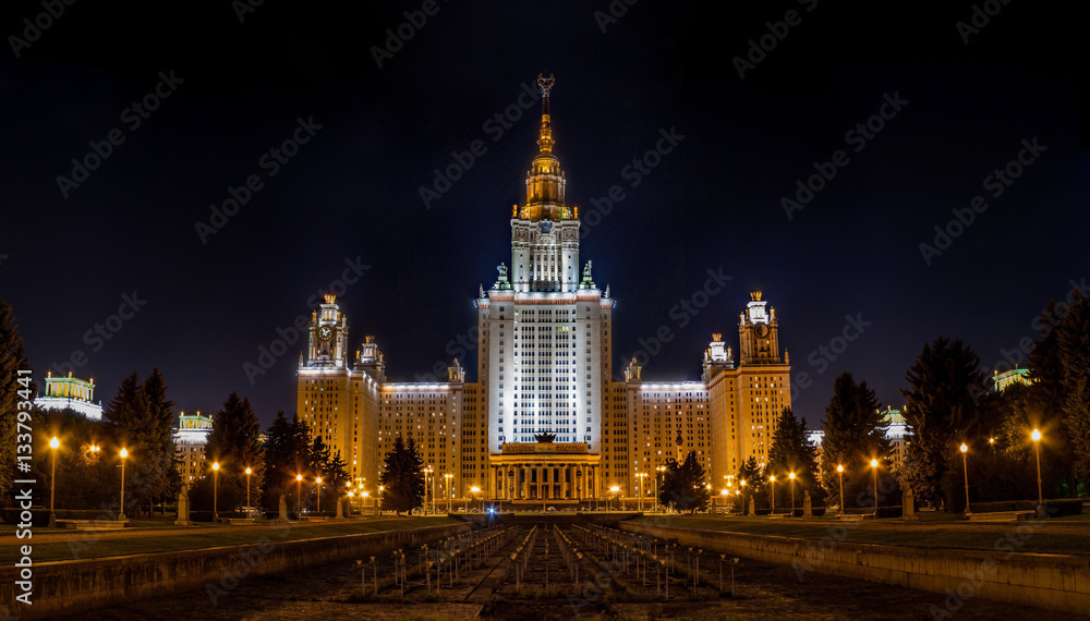 Large photo of Moscow State University of Russia at night. Clear night view on a tall famous educational building in Moscow. White illuminated university facade famous among the student. Large photo of Moscow State University of Russia at night. Clear night view on a tall famous educational building in Moscow. White illuminated university facade famous among the student.