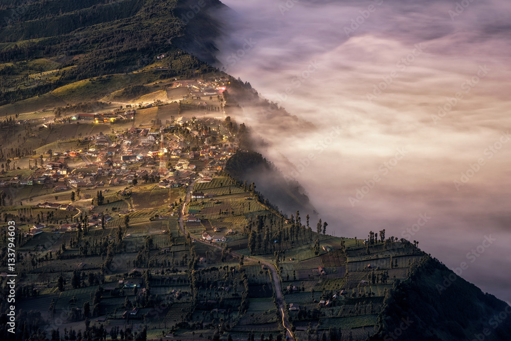 Touch of morning light on fog and mist at Cemoro Lawang village