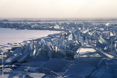 Field of broken ice along the crack in winter