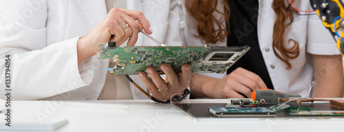 Students analyzing computer components