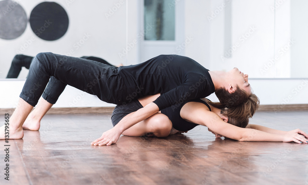 Nice slim man lying on his dance partner Nice slim man lying on his dance partner