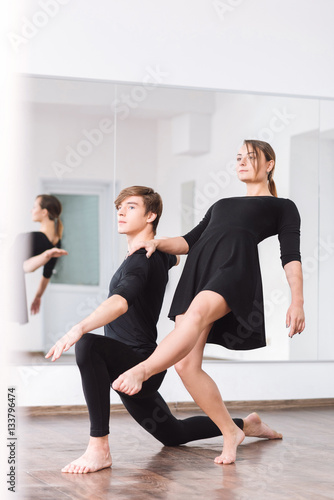 Serious talented dancer leaning backwards