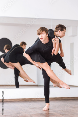 Good looking strong man practicing ballet dancing