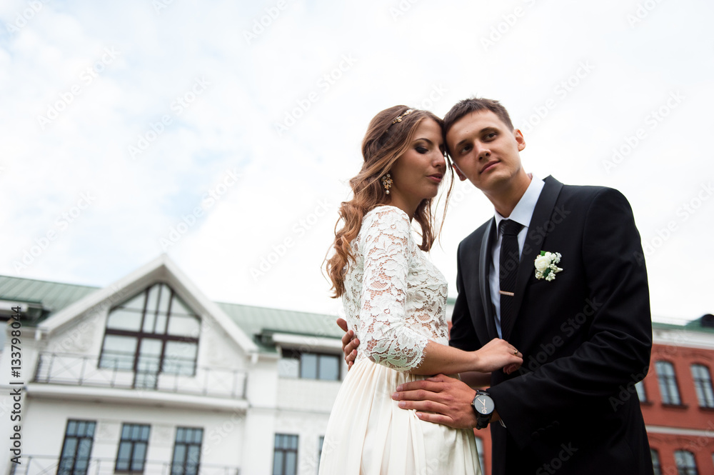 gorgeous happy wedding couple walking and kissing in the old city of Minsk, Belarus