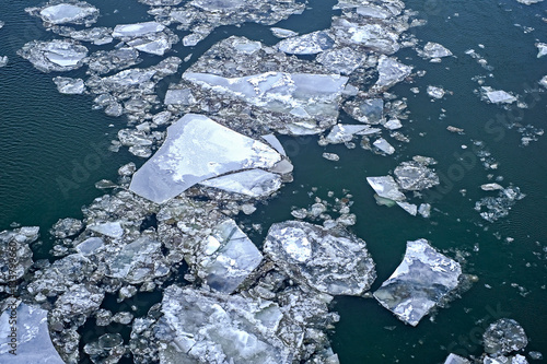 Ice floe floating on river in spring time.