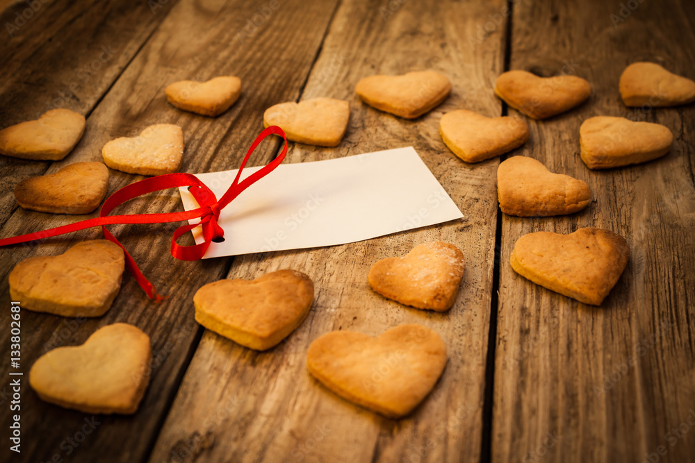 On the White Isolated Letter and Gingerbread Cookies in the Shape of Heart at Valentine Day. On the wooden background On the White Isolated Letter and Gingerbread Cookies in the Shape of Heart at Valentine Day. On the wooden background