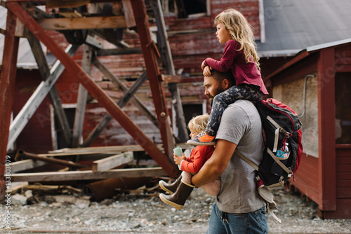Father carrying daughters