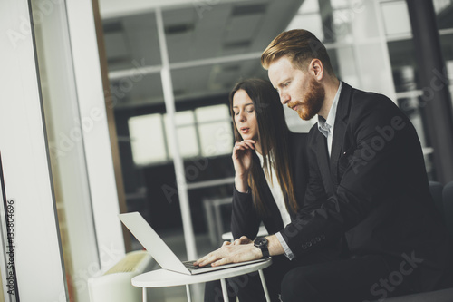 Business couple using laptop
