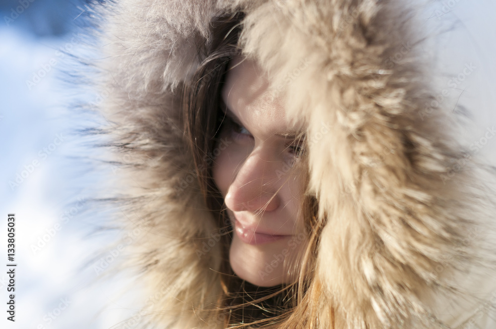 Sunny winter day , the girl in the hood